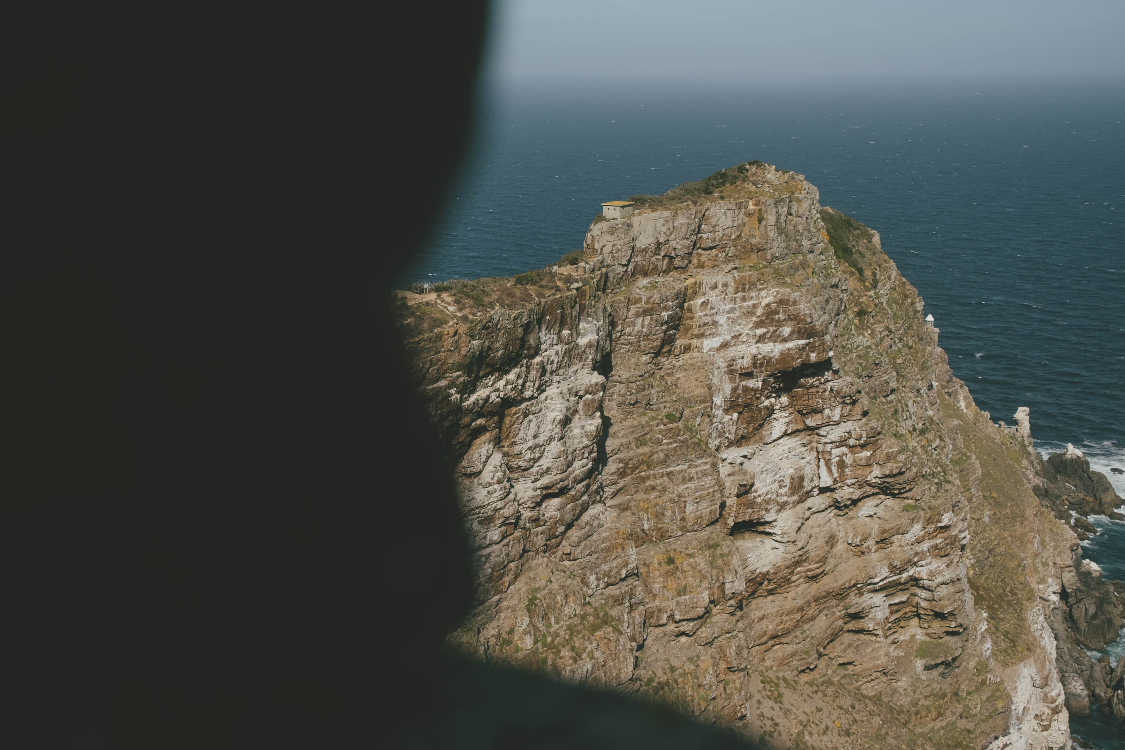 Cape Point, framed by the shadow of a nearby cliff