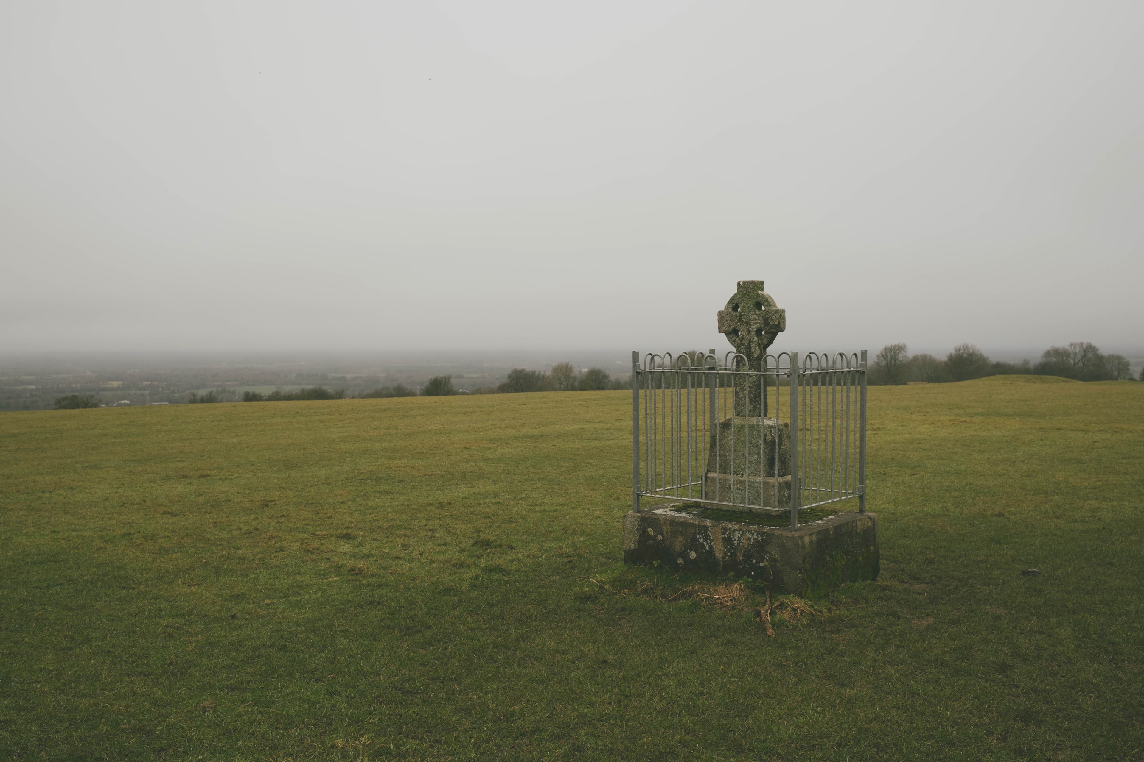 Recess in the mounds of the Hill of Tara, looking over the countryside on a cloudy, misty day