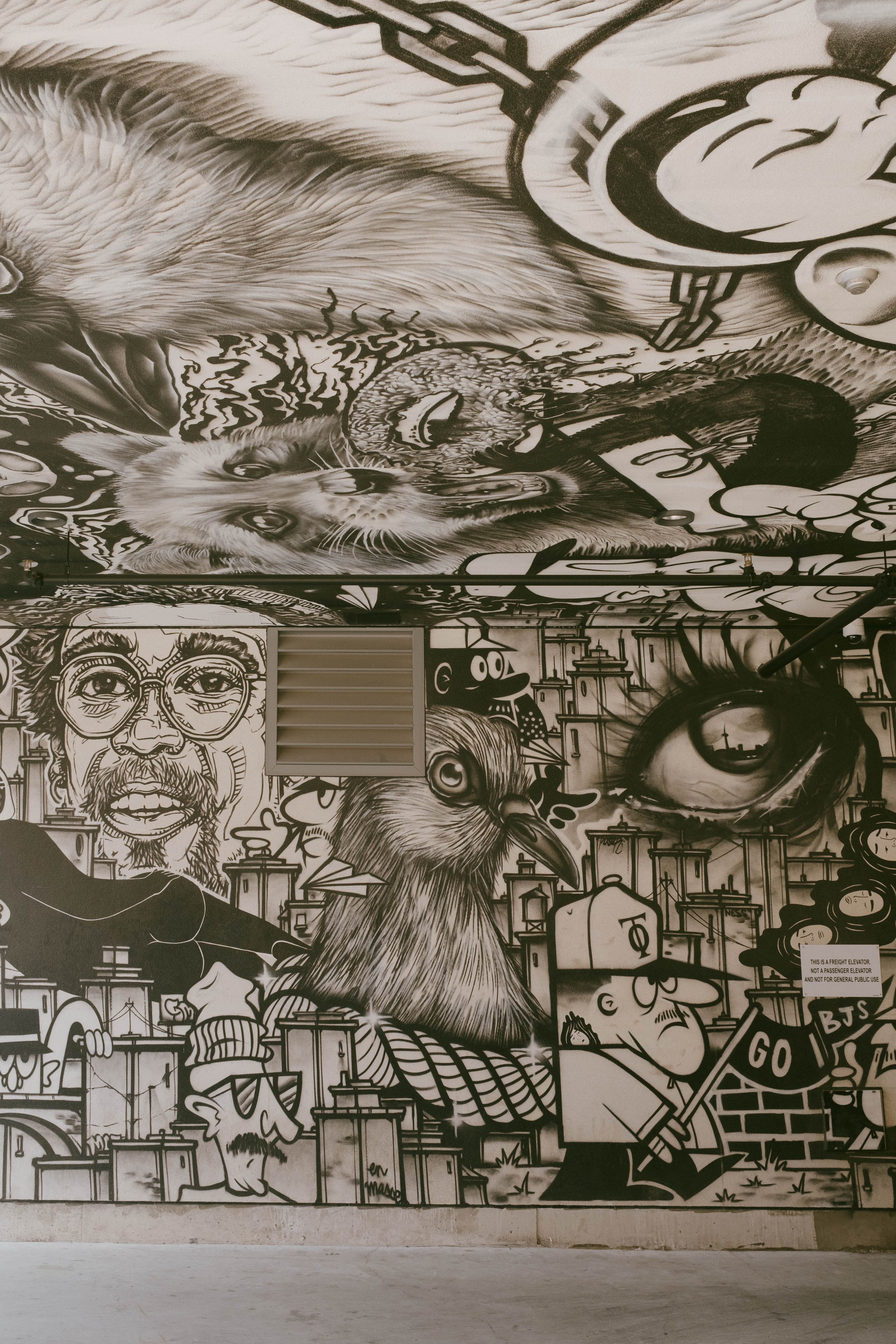Elaborate black and white mural spreading to the ceiling