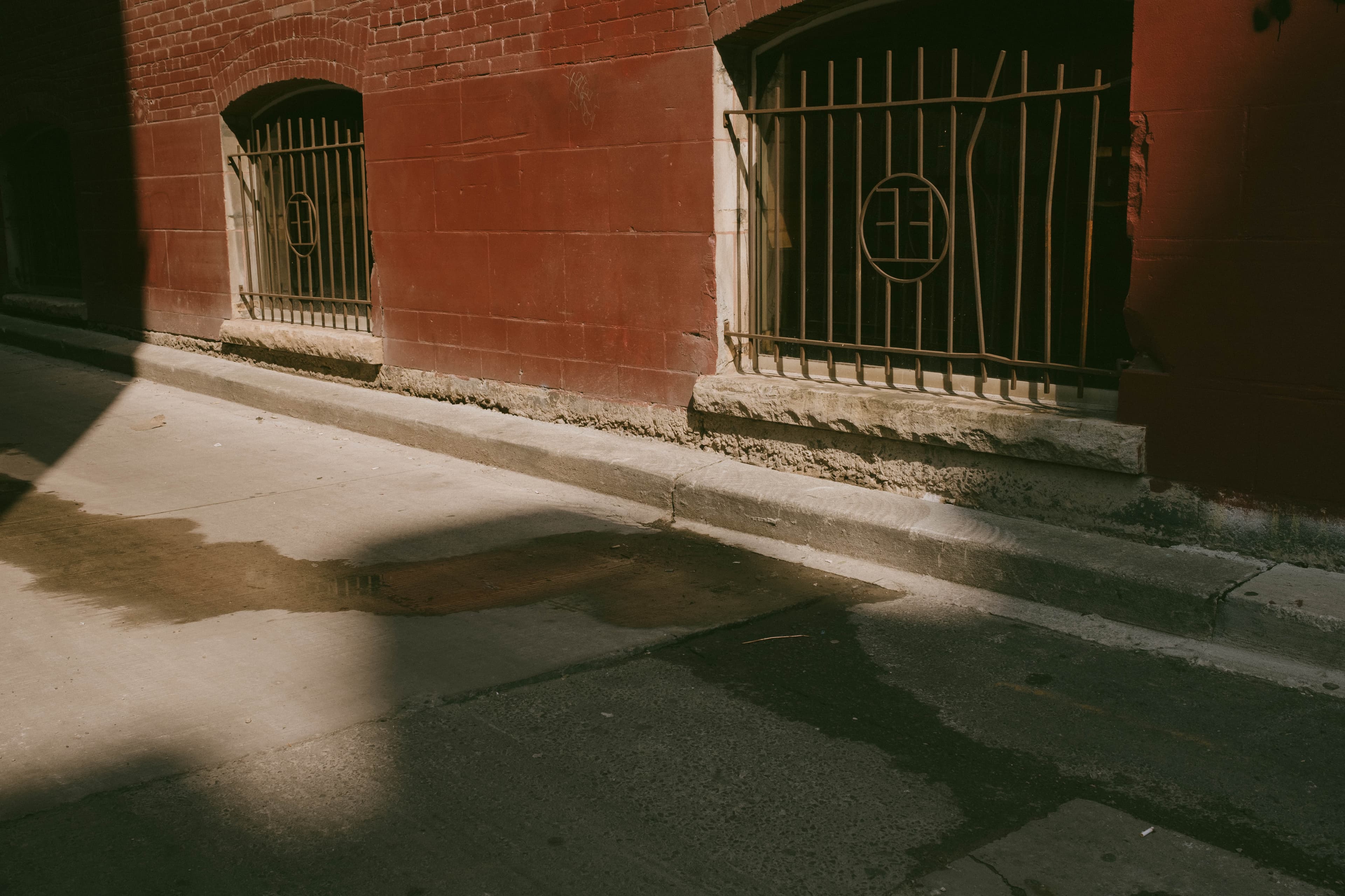 Early morning light hitting alley basement windows on a building
