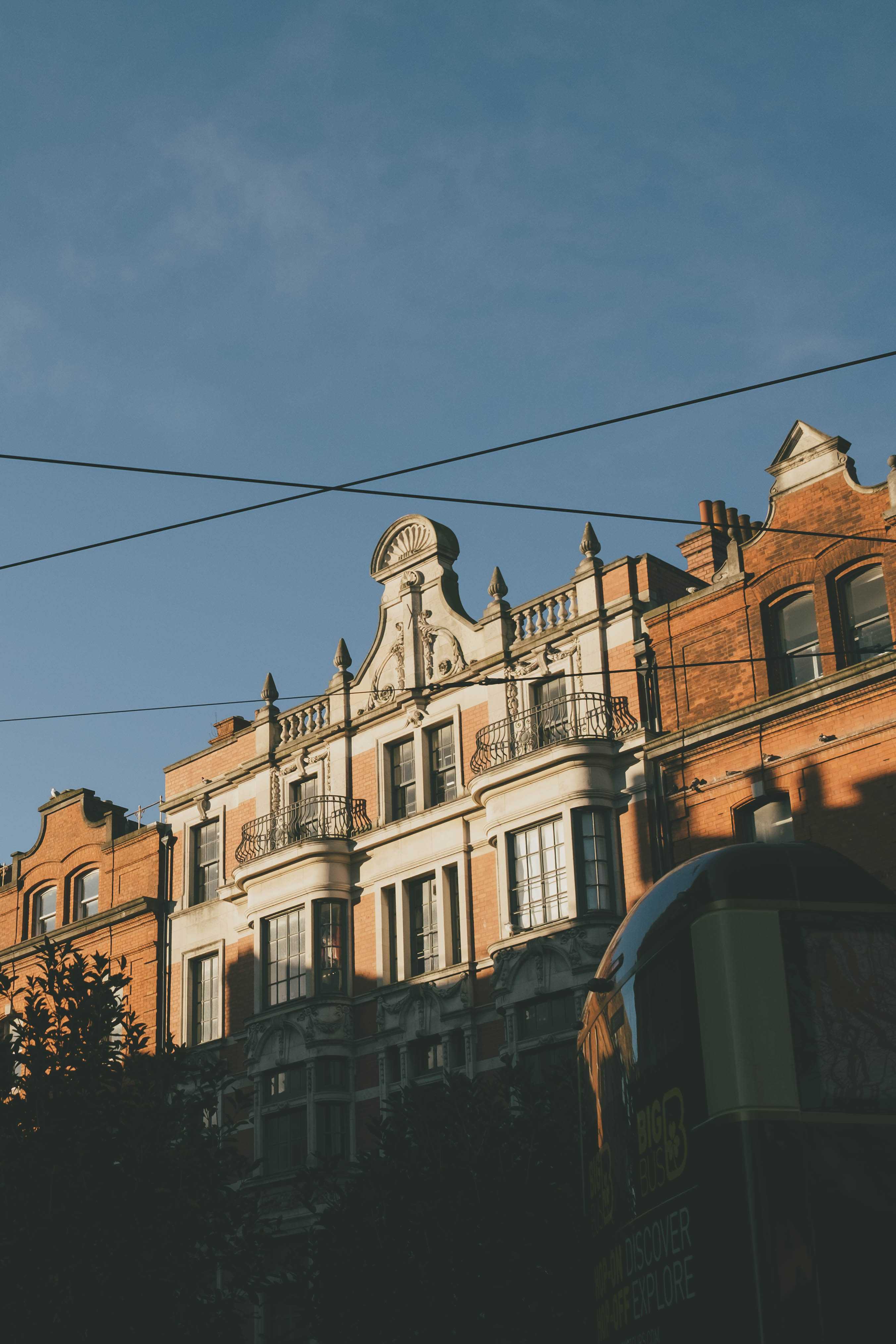 The sun hitting a group of buildings. The photo is taken from a low angle.