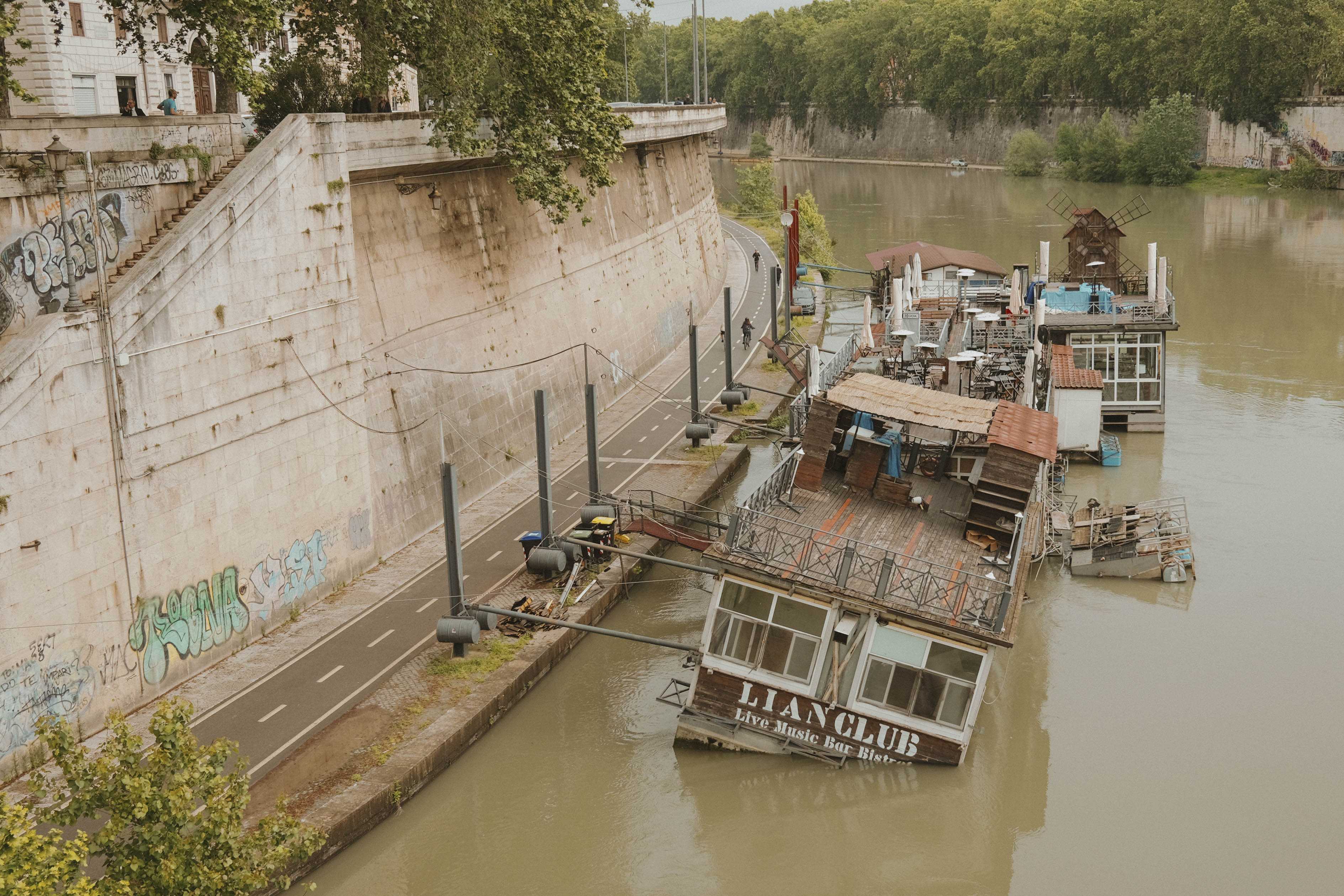 A half-sunken houseboat or floating night club
