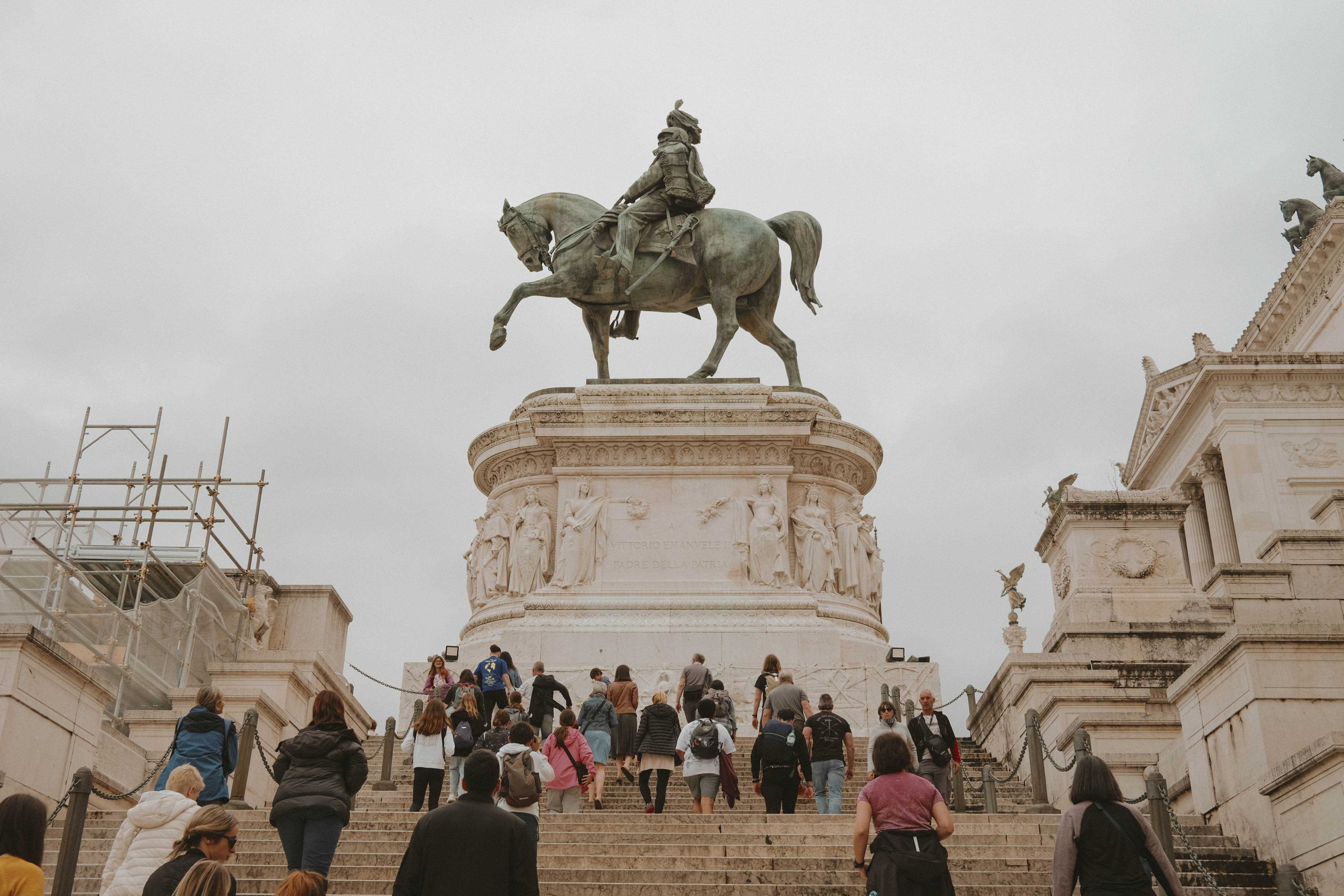 Low angle view of the horse on the Victor Emmanuel II Monument as people go up the stairs