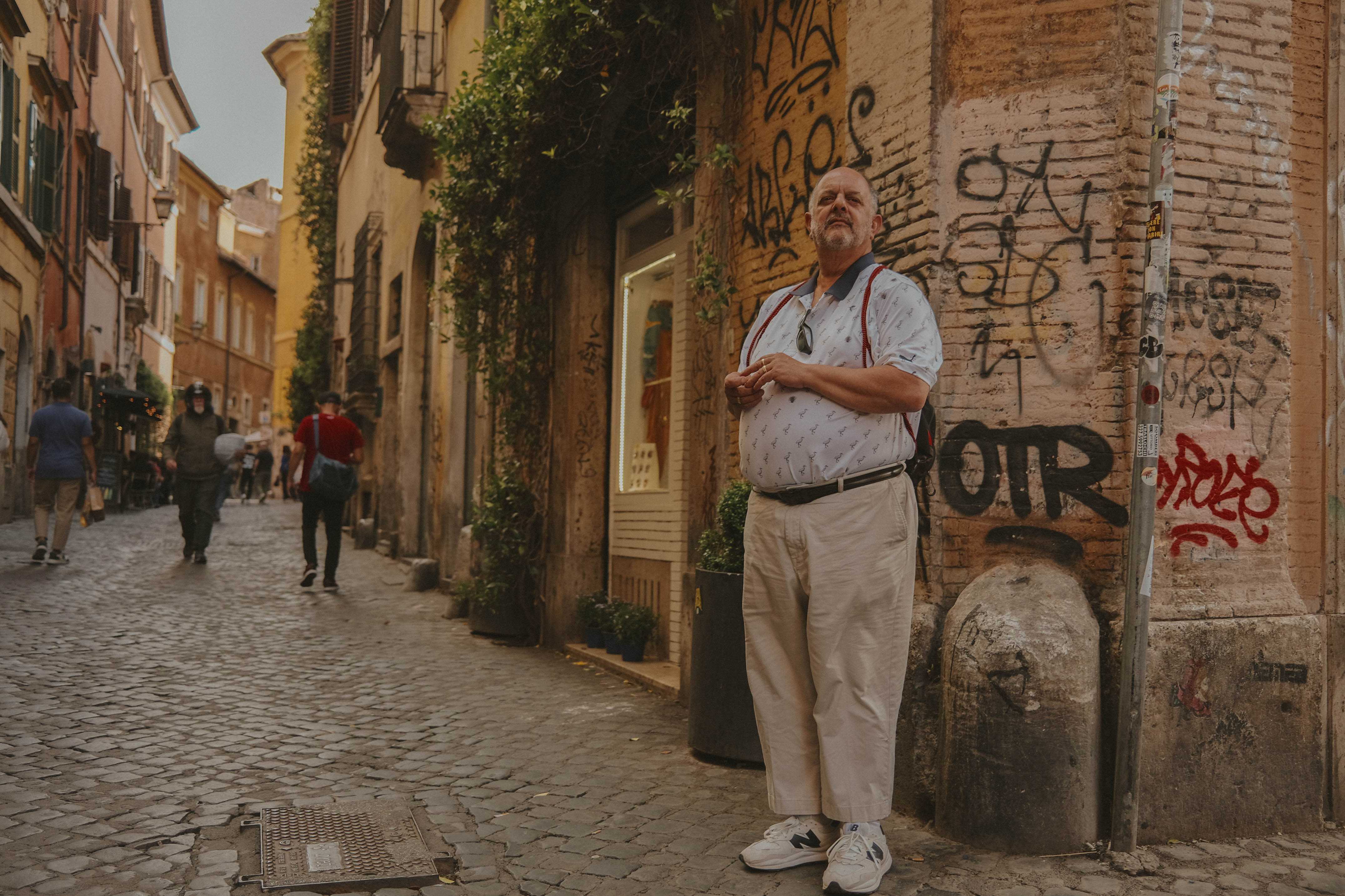 Man standing at a corning, seemingly waiting for someone