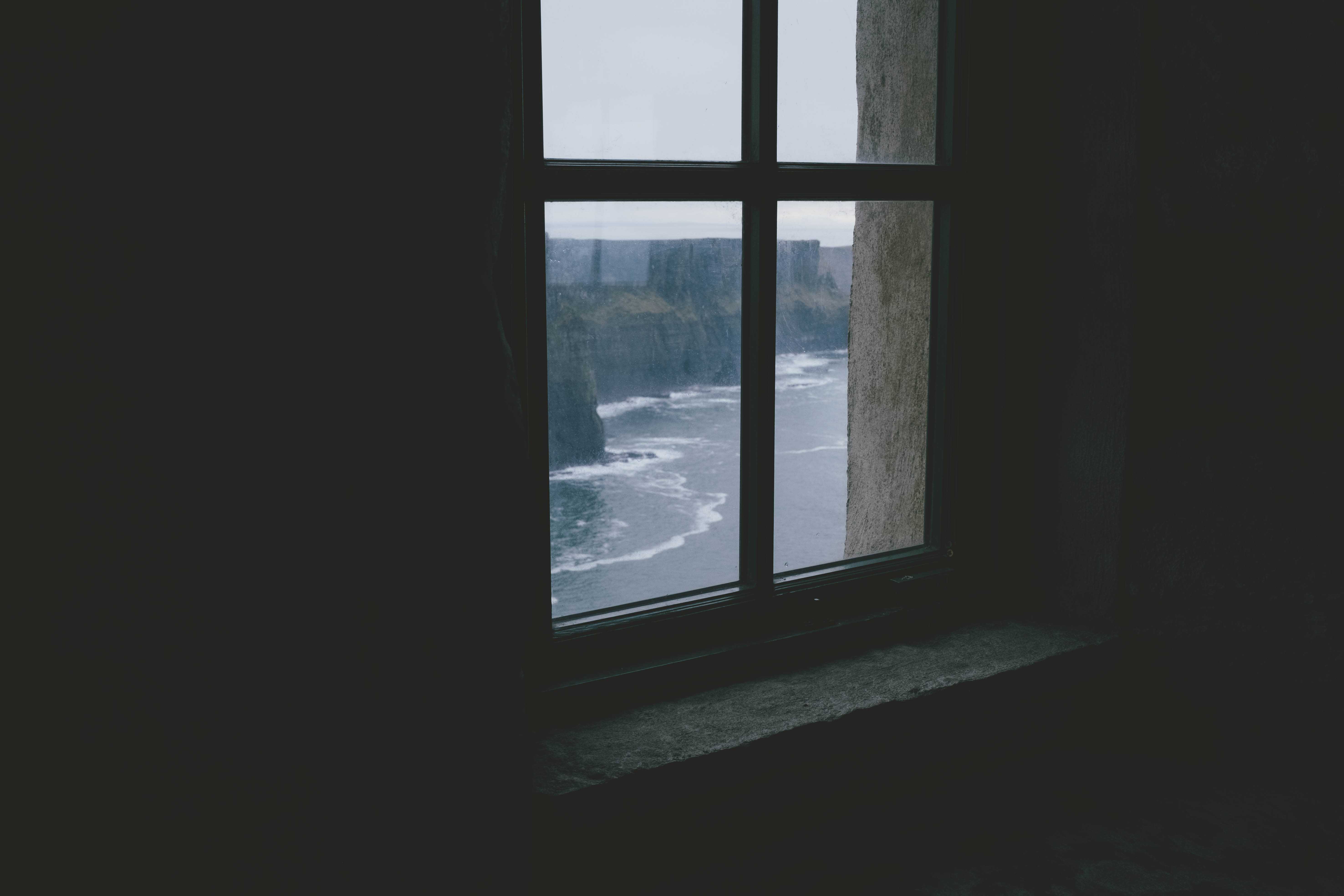 Look out at the cliffs from behind a window