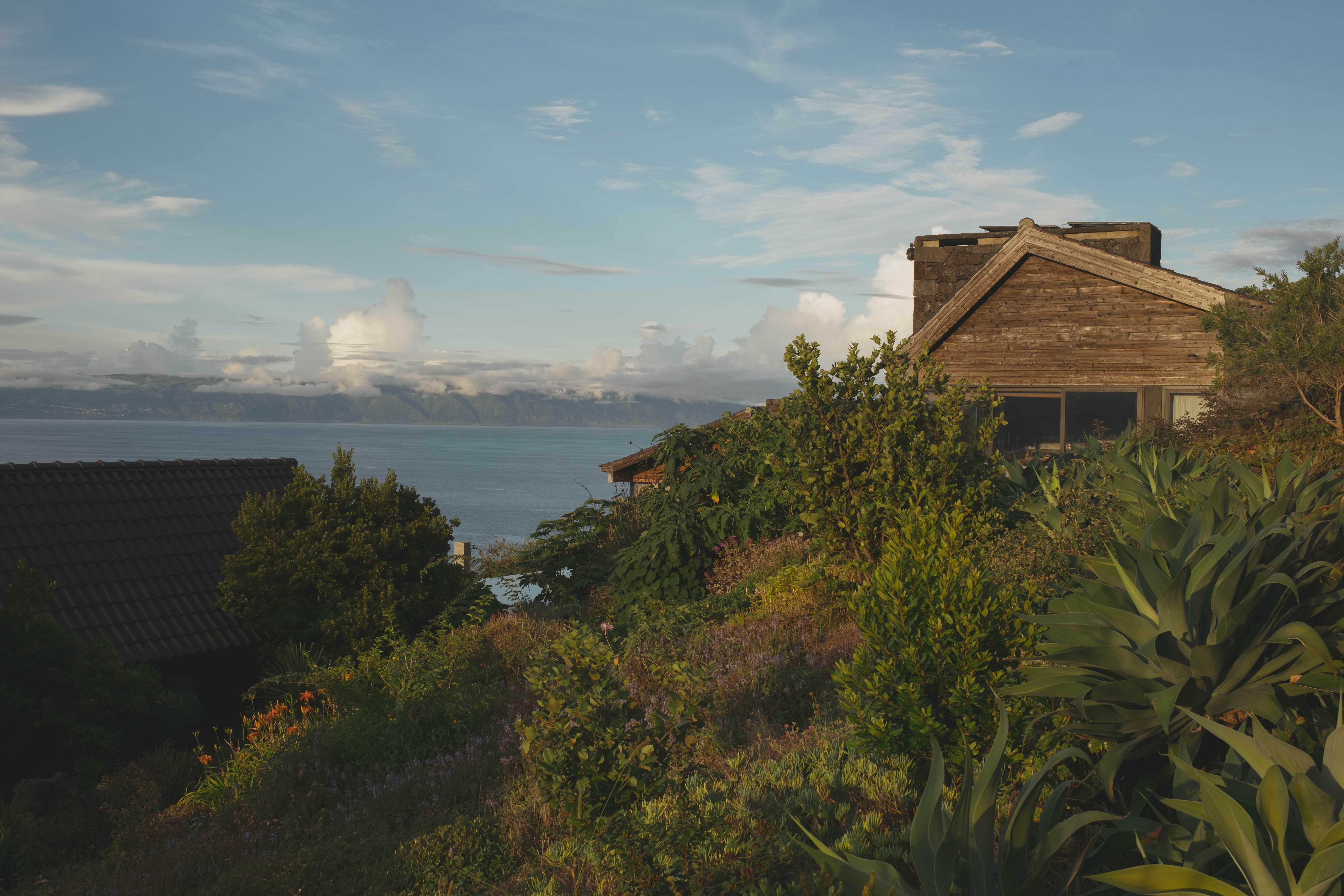 View from Lava Homes hotel with a guest house in the foreground, and in the background, the island of São João.