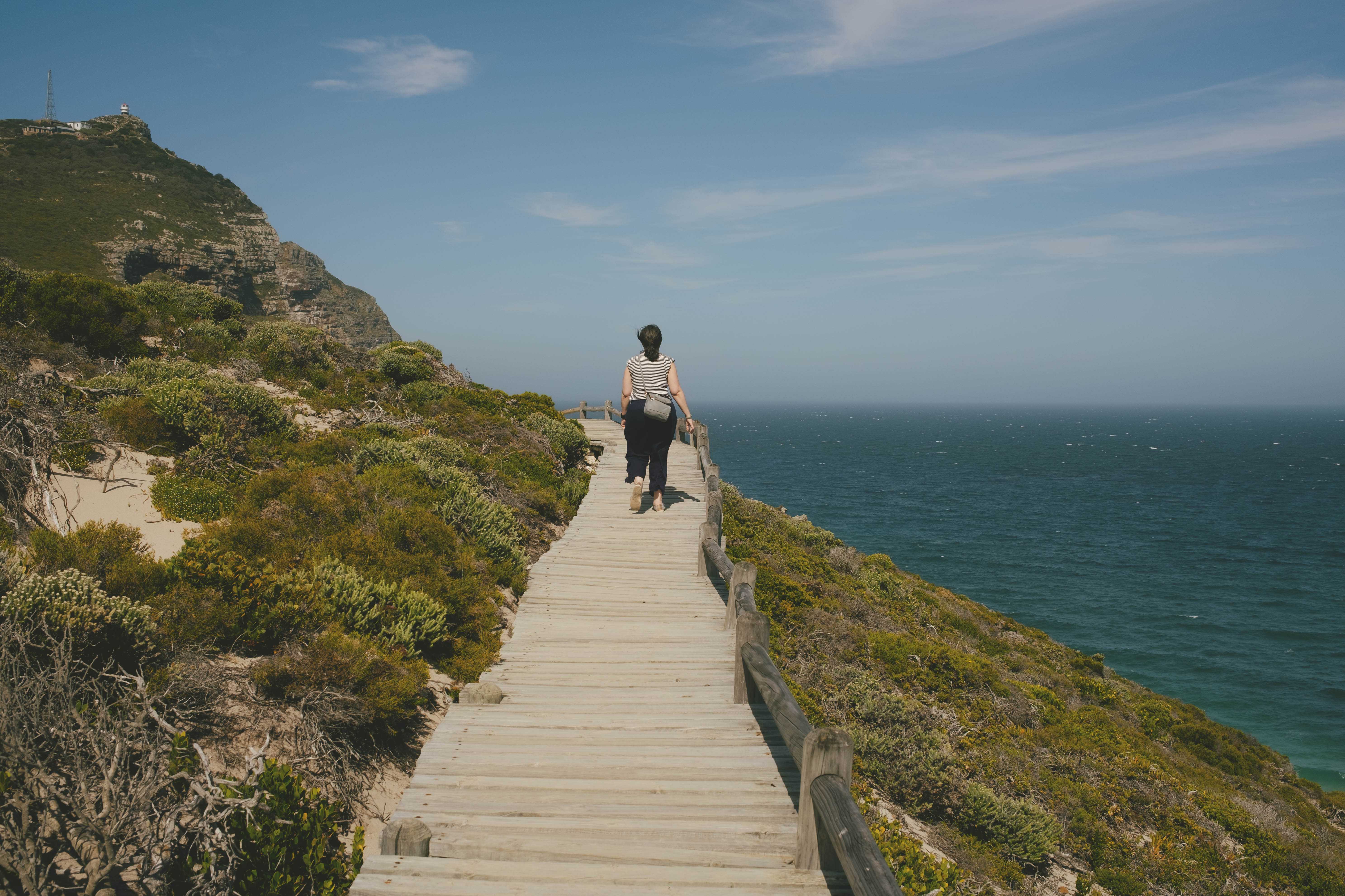 Mirna, far ahead, walking along a wooden path