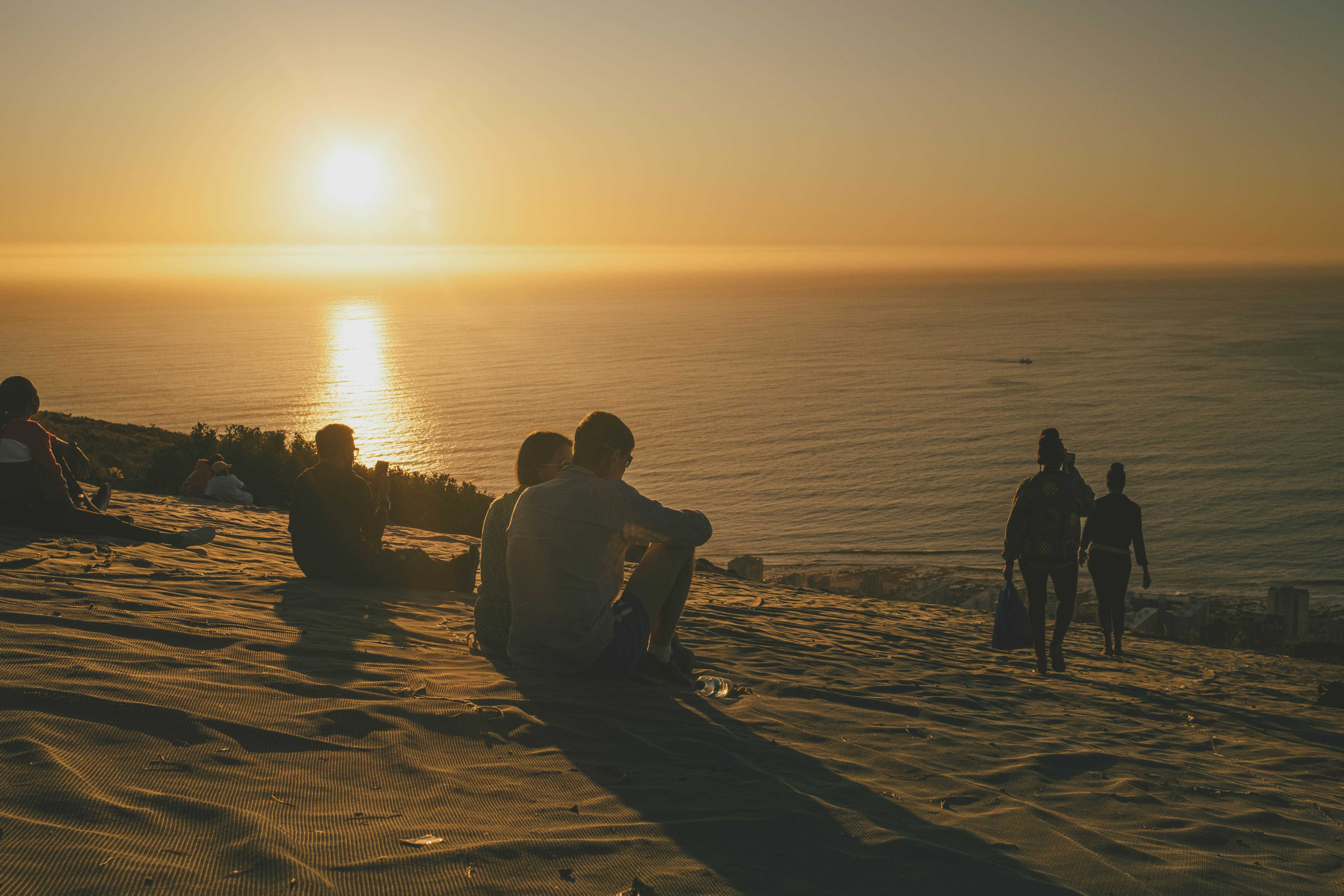 Sunset with a crowd of people relaxing to watch it on Signal Hill