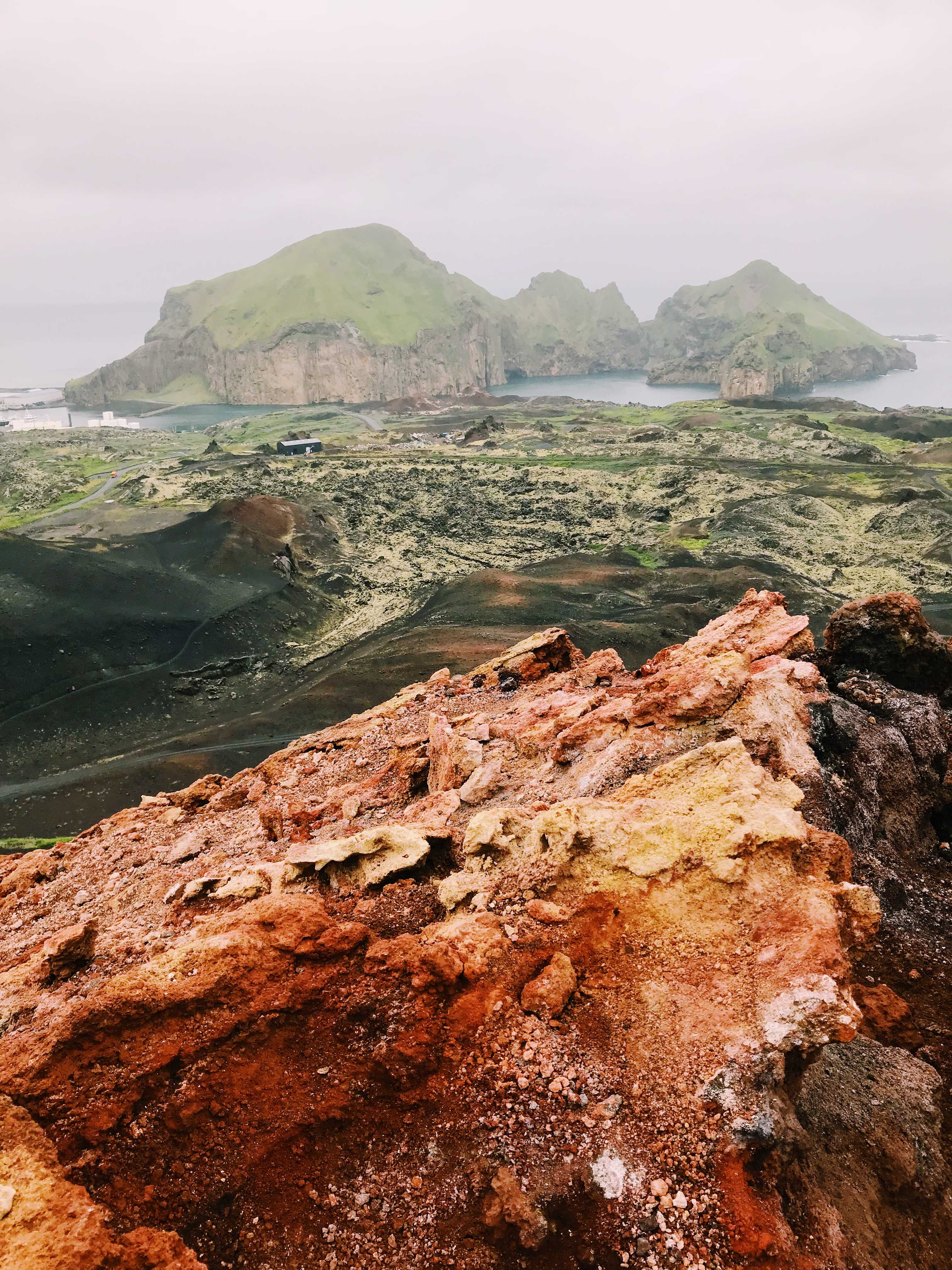 On top of Eldfell volcano looking at the buried town below